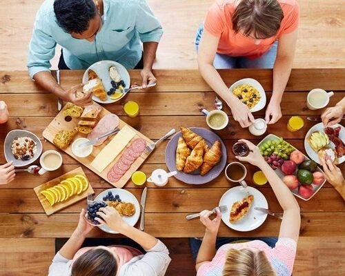 group of people having breakfast at table